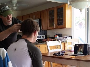 Joe Nixon gets a haircut from his dad David, with the help of Vancouver barber Farzad Salehi.