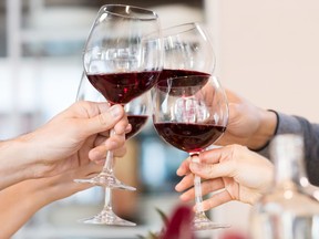 Close up of glasses raising a toast at lunch.