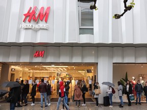 People wait in line to get into a H&M store on May 2, 2020, in Frankfurt am Main, western Germany, amid the coronavirus pandemic.