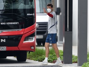 Striker Thomas Mueller wears a face mask as he leaves a training session of the German First Division Bundesliga football club FC Bayern Munich on Wednesday at the Bayern's campus in Munich, southern Germany. The Bundesliga returns to action this weekend, facing Union Berlin in an empty stadium due to the COVID-19 pandemic.