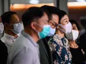 Tanya Chan (centre) of the Civic Party and other pro-democracy lawmakers gather outside the entrance of the Legislative Council for a press conference in Hong Kong late Thursday.