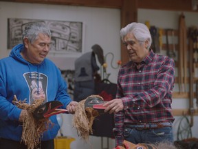 Brothers Robert and Reg Davidson, internationally recognized Haida artists, demonstrate raven rattles in Robert’s studio.
