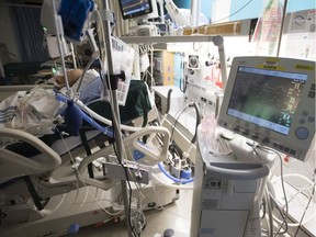A patient is attached to a ventilator in the COVID-19 intensive care unit at St. Paul's hospital in downtown Vancouver, Tuesday, April 21, 2020.