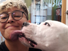 Vancouver police are investigating after an indigenous woman was mistaken for Asian and punched in the head after a man heard her sneeze. Dakota Holmes, 27, is pictured with her Dogo Argentino Kato.