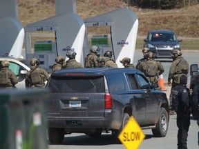 RCMP officers pictured at a gas station in Enfield, N.S. on Sunday April 19, 2020.