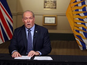 Premier John Horgan is joined by Provincial Health Officer Dr. Bonnie Henry and Health Minister Adrian Dix as they discuss reopening the province's economy in phases in response to the COVID-19 pandemic during a press conference in the rotunda at Legislature in Victoria, B.C., on Wednesday May 6, 2020.