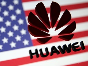 A 3D-printed Huawei logo is placed on glass above displayed U.S. flag in this illustration taken Jan. 29, 2019.