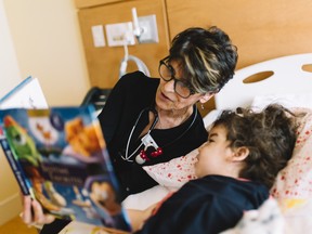 Canuck Place nurse Doreen Landry, a 25-year veteran of the nursing team, reads to Canuck Place child Lumina at Canuck Place Dave Lede House in Abbotsford.