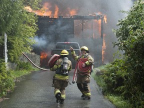 Coquitlam Fire Rescue fights a blaze at a home on Coast Meridian Road in the Burke Mountain neighbourhood Monday. The home was fully engulfed in flames when firefighters arrived.