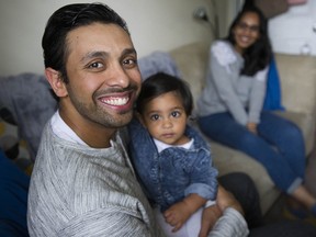 Taariq Bali with his one-year-old daughter Junnah and wife Shahira Ismail at their Delta, B.C., home. Bali has already undergone open-heart surgery to help with a genetic heart condition, but will go through another procedure soon to put a stent in his pulmonary artery.