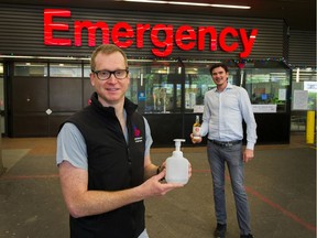 Chris Nelson, right, the owner of Pacific Sands Beach Resort in Tofino and an investor in the Shelter Point Distillery on Vancouver Island, delivers 2000 litres of hand sanitizer to VGH anesthesiologist Dr. Neil Ramsay on Sunday.