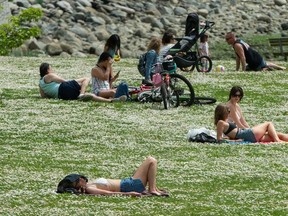 People enjoy the weather at English Bay in Vancouver, B.C., May 10, 2020.