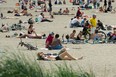 People enjoy the hot weather at English Bay beach in Vancouver.