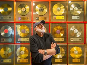 Bruce Allen poses in front of a wall of gold records  at his office in Vancouver May 12.