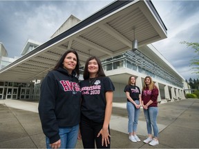 Christa Saito, with daughter Natalie (left) and Bonnie Stein and her daughter Hannah in front of Heritage Woods Secondary in Port Moody, B.C., May 12, 2020.