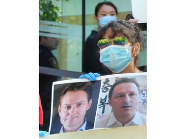 VANCOUVER, BC., May 27, 2020 - Demonstrators outside BC Supreme Court as they await The Reasons for Judgment of Associate Chief Justice Holmes in United States v. Meng regarding the issue of double criminality, during the Covid-19 pandemic,  in Vancouver BC., on May 27, 2020. (NICK PROCAYLO/PNG)   00061504A ORG XMIT: 00061504A [PNG Merlin Archive]
