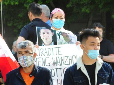 VANCOUVER, BC., May 27, 2020 - Demonstrators including Turnisa Matsedik-Qira outside BC Supreme Court as they await The Reasons for Judgment of Associate Chief Justice Holmes in United States v. Meng regarding the issue of double criminality, during the Covid-19 pandemic,  in Vancouver BC., on May 27, 2020. (NICK PROCAYLO/PNG)   00061504A ORG XMIT: 00061504A [PNG Merlin Archive]