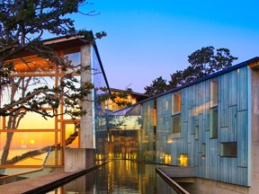 A river runs right through this modern two-story home on the Metchosin, British Columbia, waterfront.