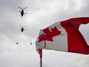 Canadian Forces CH-47 Chinook helicopters participate in a flyover of Parliament Hill in Ottawa on Friday, May 9, 2014. The Canadian Armed Forces is postponing the deployment of a warship and surveillance aircraft to help enforce United Nations' sanctions against North Korea because of the COVID-19 pandemic.