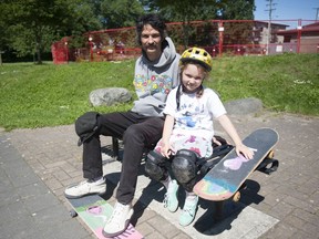 Jeffry Lee, an avid skateboarder sitting outside the fenced-off skateboard bowl at China Creek Park in Vancouver on May 26, 2020 with daughter Irene Lee, wants the Vancouver Park Board to open skateparks. For Kevin Griffin story. Credit: Mike Bell/PNG [PNG Merlin Archive]