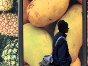 A man walks past a grocery store in Winnipeg, May 8, 2020.