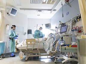 A patient receives treatment at the COVID unit at Vancouver General Hospital in this file photo.