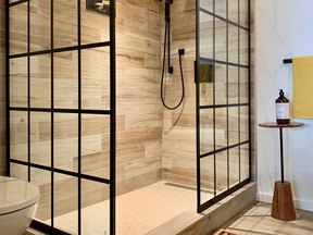 Slick tile, a 'window pane' style shower screen and warm, woodsy accents freshen a formerly lack lustre bathroom. SUPPLIED