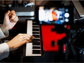 Music vlogger streaming a live video while playing piano in home studio. Getty Images stock pic. For 0630 brief vanjam