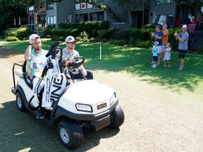 Corey Connors drives by fans as he leaves the 18th green during the second round of the RBC Heritage on Friday at Harbour Town Golf Links in Hilton Head Island, S.C.