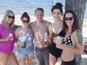 From left, Amanda Little, Raquel Pereira, Corey McLaren, Dylan Capp and Joanne Clearwater were among the first people to legally enjoy a drink Wednesday on Okanagan Lake beach.