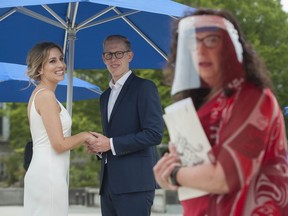 Roni Jones and Nikki Alexis are wed by Wedding Commissioner Ruth Lipton at Vancouver City Hall Friday, June 19, 2020 as part of several 'micro-weddings' held Friday at city hall.