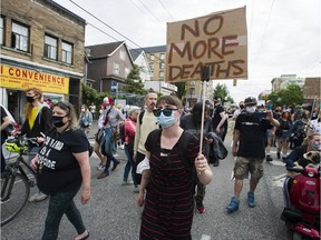 People take part in a march calling for the safe supply of street drugs, on East Hastings Street in Vancouver's Downtown Eastside neighbourhood on June 23, 2020.
