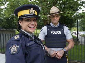 While women and visible minorities have made inroads across B.C. police forces, they are underrepresented compared with the general population in many municipalities. Pictured are Acting Insp. Veronica Fox and Sgt. Major Sebastien Lavoie outside RCMP headquarters in Surrey.