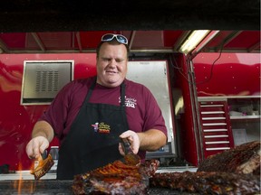 In this file photo, Rob Reinhardt of Prairie Smoke and Spice fires up some ribs at the Fair at the PNE. The PNE is cancelled this year because of the COVID-19 pandemic, but the PNE is hosting a Car-B-Q this weekend featuring Prairie Smoke among other Canadian concessionaires.