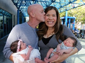 Margo and Ian Sheldon hold their two babies Sofia Grace and Austin Olivier in Victoria, Monday, June 22, 2020. Sofia is 4 days older and born by surrogate Meena Buckham, not shown. They are now being discharged and slowly making their way home to Jasper, Alberta.