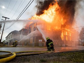 Firefighters battle a three-alarm fire at a four storey residential building under construction in Vancouver, on Thursday, June 18, 2020.