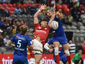 Canada (red) and France battle for the ball during the HSBC World Rugby Sevens Series at B.C. Place stadium in Vancouver on March 7, 2020.