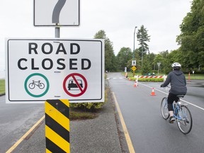 A cyclist enters Stanley Park along Beach Ave. on June 4, 2020. Vehicles have been prohibited from entering the park since April 8, but the park board voted early Friday to reopen a lane to cars.