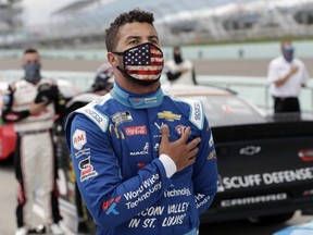 Driver Bubba Wallace stands for the national anthem prior to the NASCAR Cup series race at Homestead-Miami Speedway, in Homestead, Fla., June 14, 2020.