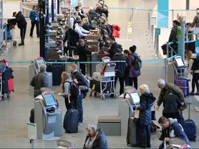 Travellers move through the Calgary International Airport on Dec. 16, 2019.