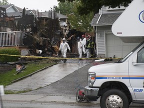 Investigators probe site of house fire at 19673 Wakefield Drive in Langley on June 15, 2020.