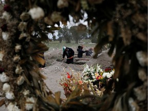 Cemetery workers dig new graves at a designated area for people who died of the coronavirus disease (COVID-19) at the San Lorenzo Tezonco cemetery in Mexico City, Mexico, June 3, 2020. REUTERS/Carlos Jasso