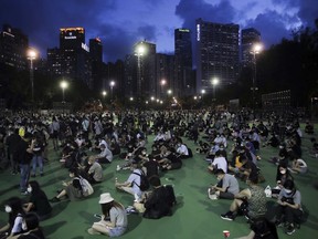 Participants hold candles as they gather for a vigil to remember the victims of the 1989 Tiananmen Square Massacre, despite permission for it being officially denied, at Victoria Park in Causeway Bay, Hong Kong on June 4, 2020. China is tightening controls over dissidents while pro-democracy activists in Hong Kong and elsewhere try to mark the 31st anniversary of the crushing of the pro-democracy movement in Beijing's Tiananmen Square.