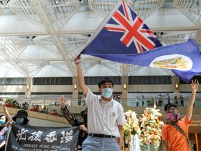 A pro-democracy demonstrator waves the British colonial Hong Kong flag during a protest against new national security legislation in Hong Kong, China on June 1, 2020.