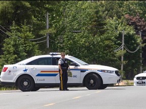Members of the RCMP control the scene where a man was shot on Friday night, near Miramichi, N.B. on Saturday, June 13, 2020.