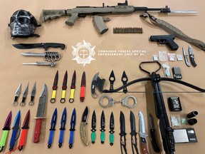 B.C.'s anti-gang police and Prince George Mounties seized a loaded semi-automatic rifle, a cross bow, brass knuckles, knives and drugs packaged for sale during traffic stops targeting the street level drug trade in the northern B.C. city last week. Credit: BC-CFSEU