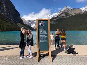 Tourists take photographs at Lake Louise on June 12.