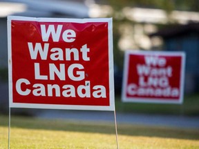 Signs reading "We Want LNG Canada" stand on a lawn in a residential area of Kitimat.