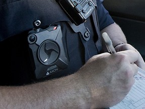 A police officer near Boston wears a body camera while writing a citation.