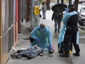 Paramedics help a man suffering a drug overdose in the Downtown Eastside.